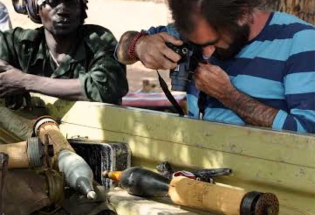 Man photographing weapon