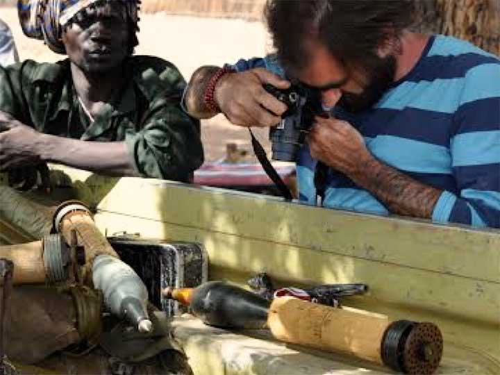Man photographing weapon